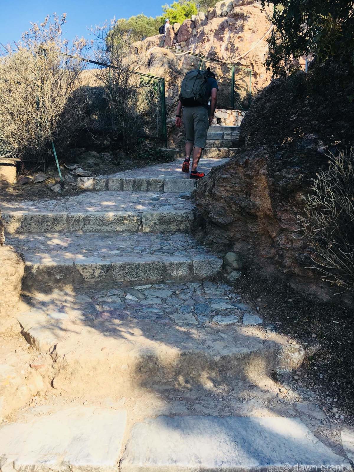 A close look at stone stairs that have been worn down by feet climbing them over centuries.
