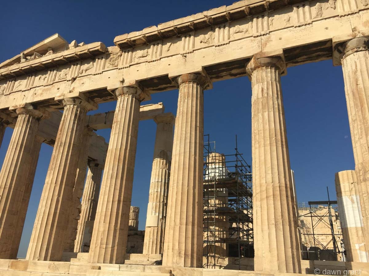 A side view of the Acropolis showing columns and detailed stonework across the top of the structure.