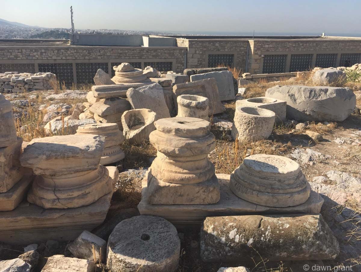 Several round artifacts laying at the bottom of the hill.